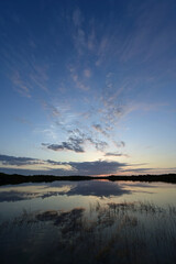 Colorful sunrise reflected in the calm water of Nine Mile Pond in Everglades National Park, Florida.