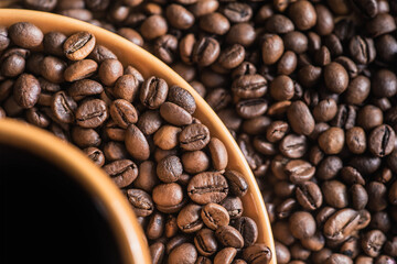 coffee background. coffee mug. copy space with coffee beans. coffee beans on the dining table. closeup of coffee beans. coffee beans on a plate