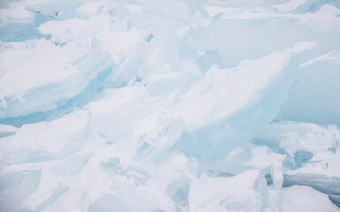 Blue transparent beautiful ice blocks, closeup view, abstract background, horizontal, high key