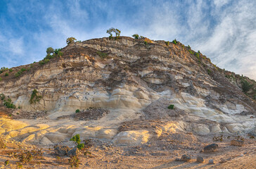 Fototapeta premium Amazing scenery of Rainbow mountain and blue sky background in sunset. Colorful landscape, rainbow hills, unusual colored rocks, sandstone erosion 