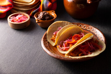 Tacos de Cochinita Pibil. Typical Mexican stew from Yucatan, made from pork marinated with achiote and generally accompanied with beans and red onion with habanero chili