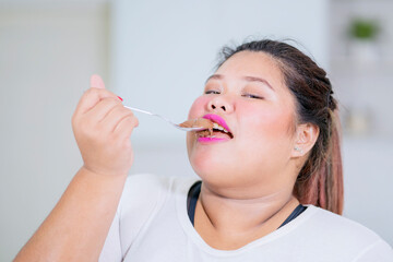 Close up of fat woman enjoying chocolate cream