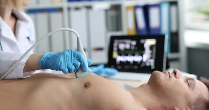 Doctor makes chest x-ray to man on ultrasound scanner closeup