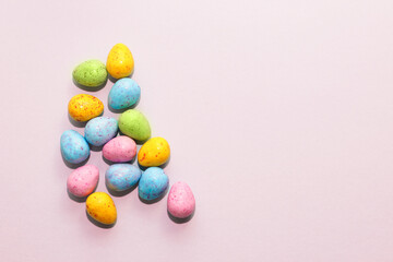 Multi-colored Easter decorative eggs on a pastel background.