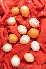 Creative Easter egg concept on .fabric under water. .Easter decoration of colored eggs. .Wavy background, flat lay.