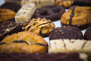 Chocolate biscuits and waffles on light background