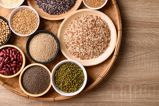 Various cereal, grain, bean, legume and seed in bowl on wooden background, Food ingredients, Table top view © nungning20