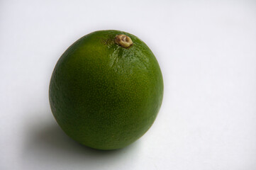 Close-up of lime on white background. Copy space and food concept