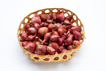 Shallots onion isolated in bamboo basket on white background.