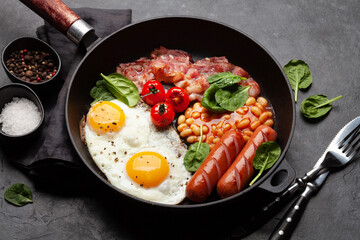 English breakfast with fried eggs, beans, bacon and sausages