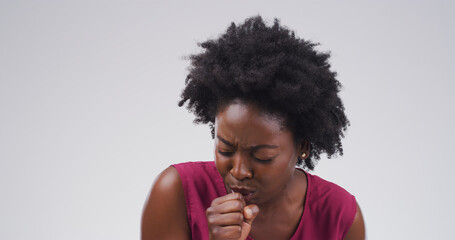 Shes gonna need a few days off. Studio shot of an attractive young woman coughing against a grey background. - Powered by Adobe