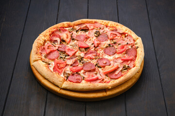Pizza with salami, mushrooms and tomato