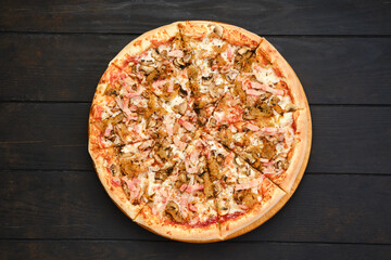 Pizza with bacon, ham, champignon and onion