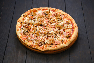 Pizza with bacon, ham, champignon and onion