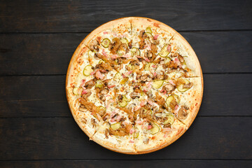 Pizza with bacon, ham, champignon, pickled cucumber and onion
