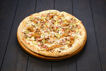 Pizza with bacon, ham, champignon, pickled cucumber and onion