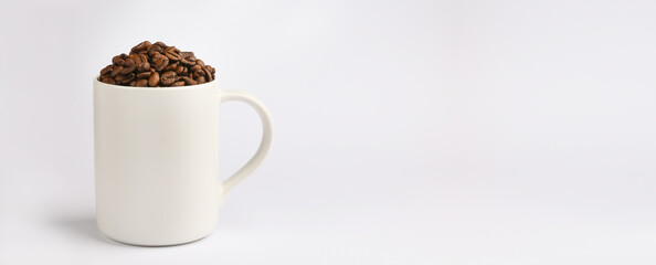 One white coffee mug, fresh roasted coffee beans, light background, place for text