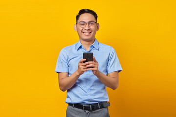 Smiling young asian man Asian in glasses reply to incoming messages on mobile phone isolated on...