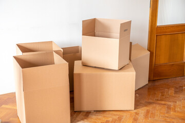Cardboard boxes on the parquet floor. Buying a new home.