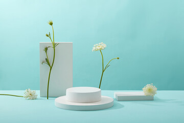 A front view of white podium decorated with flower and blue background with blank space for...