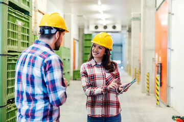 A female manager with tablet giving suggestions about productivity in factory.