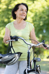Fototapeta premium mature woma is happily cycling