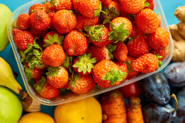 Flat lay of ripe organic healthy food Fruits, microgreens, vegetables on blue  background, copy space for text, top view, market local farm concept, harvest, food delivary, diet, vegan concept.
