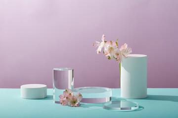 A front view of white and transparent podium decorated with flower and purple background with blank space for advertising 