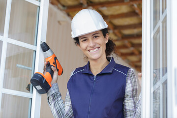 smiling woman builder with building tool