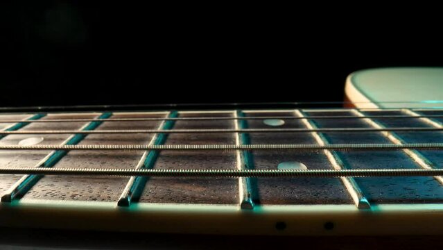 Acoustic guitar fretboard macro closeup slider shot