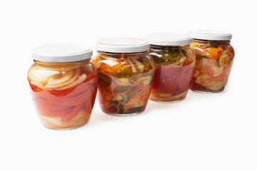 Homemade canned various vegetables with spices in glass round jars