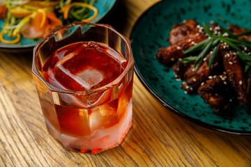 Thai food, chicken legs cooked in sauce in a plate on a wooden table