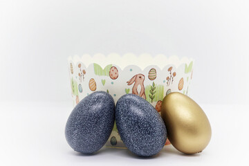 Painted Easter eggs and paper packaging for Easter cakes