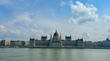 Fototapeta premium Hungarian Parliament building in Budapest night photography of bright yellow illuminated walls and dark blue sky near the Danube River. High quality 4k footage 03.04.22 Budapest, Hungary