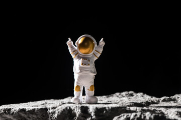 Spaceman on surface of rocks.  Astronaut in deep black space. © zhikun sun