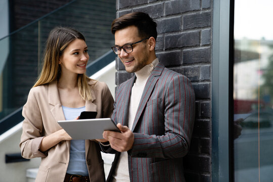 Portrait Of Successful Business People Working, Talking Together In Urban Background.