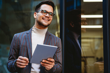 Portrait of successful business man, entrepreneur working in urban background