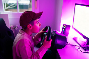 Surprised boy playing video game on computer at home