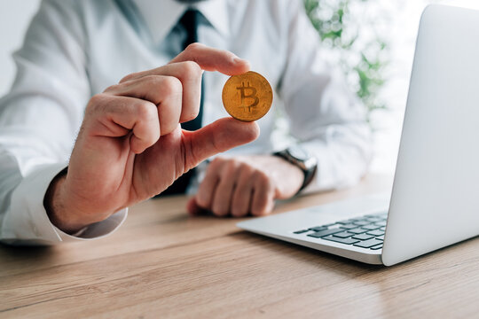 Bitcoin cryptocurrency investor concept, businessman offering one crypto currency coin
