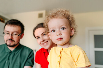 Cute girl with parents at home