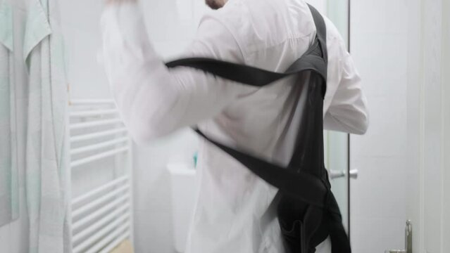 Headless person wearing white shirt in bathroom put on posture belt 4K
