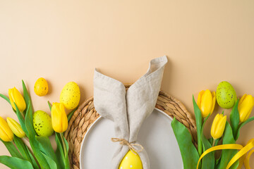 Flay lay Easter composition with plate, easter eggs decoration and yellow tulips flowers on modern...