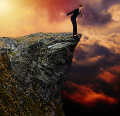 Businesswoman on the edge of a cliff