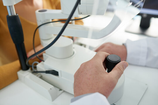 Close-up image of doctor using tonometer to measure intraocular pressure of patient
