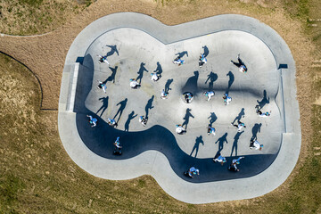 Young woman skateboarding at pump track