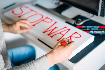 Person writing stop war banner