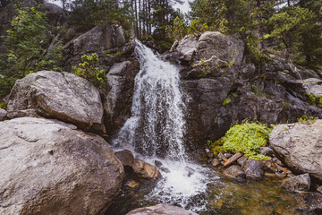 Fototapeta na wymiar Idyllic waterfall in the middle of a forest