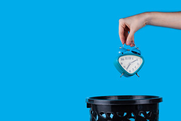 The alarm clock is thrown into the trash can. B