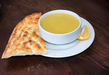 Traditional Turkish, Asian, red lentil soup served with a slice of lemon and pita bread