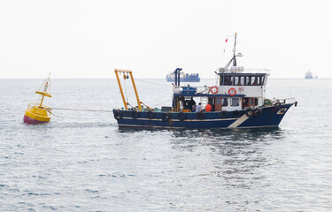 Service boat is towing a buoy in Avcilar port